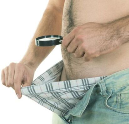 a man examines his penis and wants to enlarge it